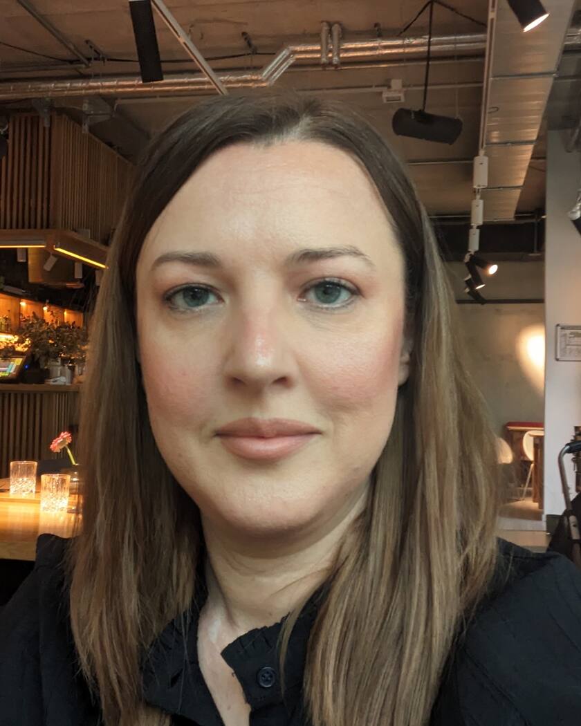 Kateryna Logoshko, mathematics tutor in Berlin — head-and-shoulders portrait, dark shirt, looking at the camera